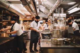 Restaurant kitchen crew in action Restaurant kitchen crew preparing food.